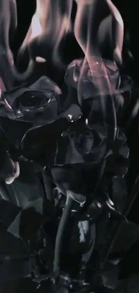 This dynamic phone live wallpaper features a beautiful bouquet of flowers in a vase intertwined with black flames in a futuristic digital art style