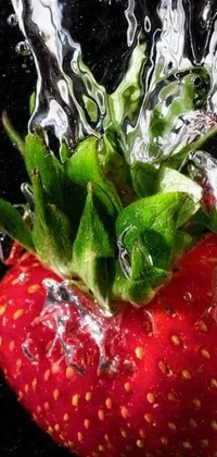 This phone live wallpaper showcases a stunningly realistic close-up of a strawberry getting splashed with water droplets against a backdrop of berries' internal structure