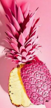 This phone live wallpaper features a stunning close-up of a colorful pineapple on a bright pink surface