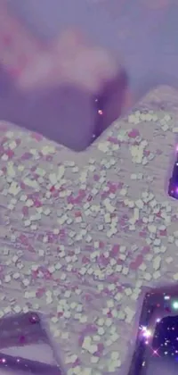 This live wallpaper features a stunning close-up of a star-shaped cookie on a plate set against a whimsical and enchanting purple background filled with glittering sparkles and tiny stars