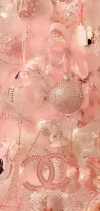 Decorate your phone with a gorgeous live wallpaper featuring a white Christmas tree adorned with pink ornaments