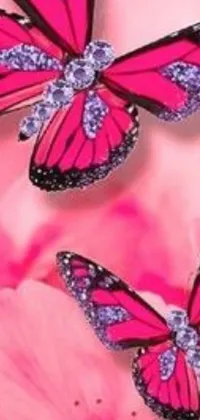 This stunning phone live wallpaper features delicate pink butterflies perched atop a vibrant pink flower, adorned with an impressive array of sparkling jewels
