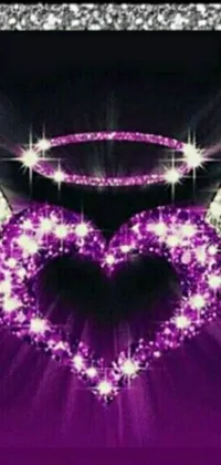 This phone live wallpaper displays a colorful image of a heart with wings on a vibrant purple background