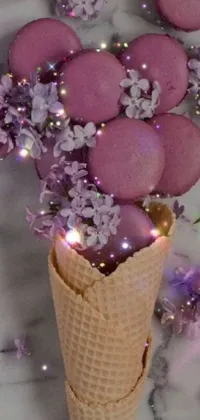 This lovely phone live wallpaper features a scrumptious ice cream cone filled with purple flowers, a shiny macaron and surrounded by sparkling glitter