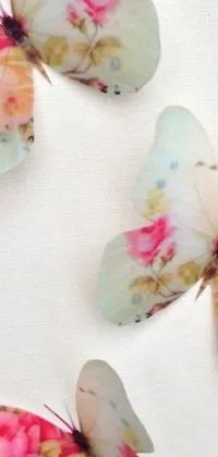 This phone live wallpaper showcases a colorful imagery of butterflies perching on a white surface