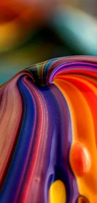 This mobile wallpaper features a captivating close-up photo of a colorful object on a table