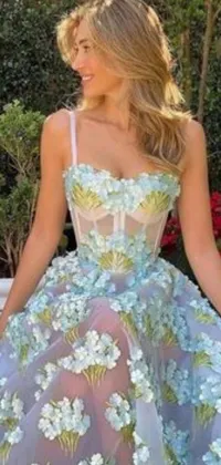 This live wallpaper showcases a beautiful floral dress on a woman against a light blue background