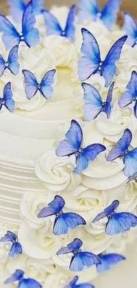 This phone live wallpaper showcases a beautiful white cake adorned with charming blue butterflies