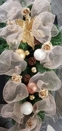 This phone live wallpaper showcases a beautifully detailed close-up of a Christmas wreath set on a table