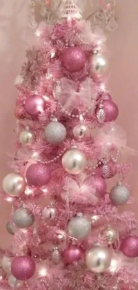 This Christmas-themed phone live wallpaper features a beautiful pink and silver decorated tree adorned with ornaments
