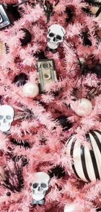 Get into the spooky holiday spirit with this phone live wallpaper featuring a pink Christmas tree adorned with black and white ornaments and keys