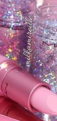 This phone live wallpaper showcases a vibrant and playful aesthetic with a pink lipstick and a jar of glitter as the focal point