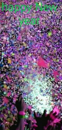 This phone live wallpaper features a dynamic party scene with confetti being thrown and iridescent colors creating a kinetic-pointillism effect