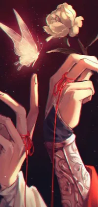 This phone live wallpaper depicts a close up of a bird being held by someone with red rooted hands and long fingers