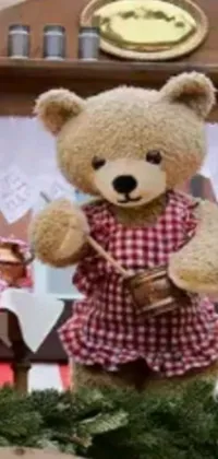 This adorable phone live wallpaper showcases a cute teddy bear dressed in charming red and white checkered dress