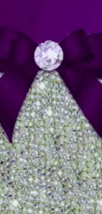 This phone wallpaper showcases a stunning close-up of a purse with a beautiful bow on it surrounded by purple crystals, giving it a distinct elegance