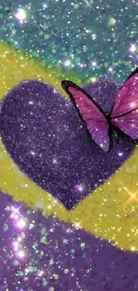 This colorful live phone wallpaper features a pink butterfly sitting on a purple heart, set against a beachy background full of shimmering glitter and fine sand