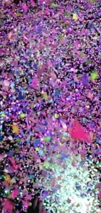 This phone live wallpaper features a vibrant crowd throwing colorful confetti in the air, surrounded by microscopic patterns and holographic elements