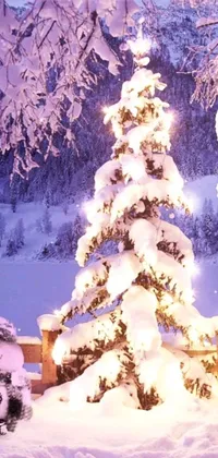 This mobile wallpaper showcases two cute snowmen standing beside a Christmas tree on a snowy day