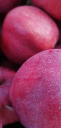 This live wallpaper features an eye-catching close-up photo of a pile of bright red apples, stacked delicately on top of each other