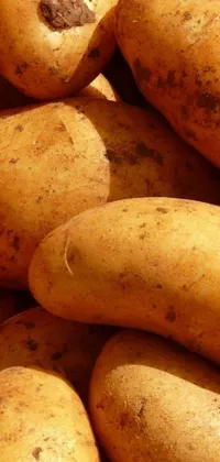 This phone live wallpaper showcases a close-up portrait of a stack of potatoes in a natural brown shade