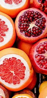 This live wallpaper for your phone showcases a vibrant digital art image featuring a colorful assortment of oranges and pomegranates