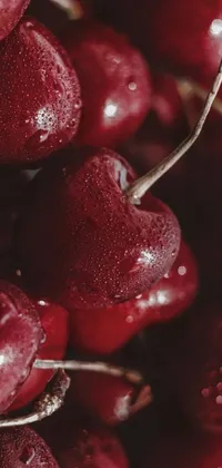 This live wallpaper features a bright and vibrant image of fresh cherries up close