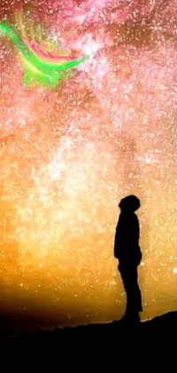 This live wallpaper features a stunning scene of a person standing on a hill under a colorful sky, with elements of light and space, multiverse, and cosmic visuals