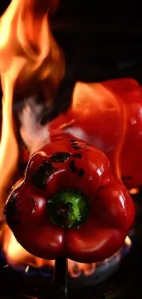 This live wallpaper features a stunning close-up of a red pepper on a grill, capturing the heat and intensity of the cooking process