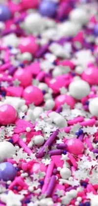This phone live wallpaper features a playful scene of sprinkles bouncing on a table against a colorful backdrop of purples, pinks and whites