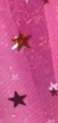 This live wallpaper features a close-up view of a striking pink fabric adorned with charming stars