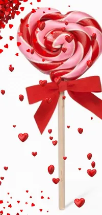 Enjoy the mesmerizing swirl of a red and white lollipop on a stick with this phone live wallpaper