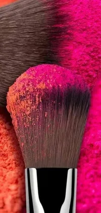 This live phone wallpaper features two makeup brushes in natural beauty colors