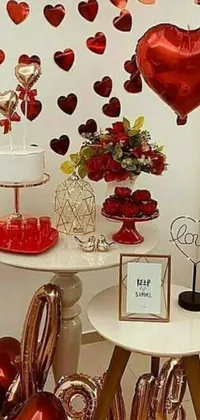 Looking for a phone wallpaper that exudes celebration, love, and happiness? Check out this live wallpaper with a table bursting with red heart-shaped balloons, a picture, cake art, listing image, gold and red metal decor, and an assortment of furniture