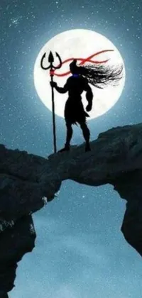 This dynamic live phone wallpaper depicts a man on a cliff beneath a full moon, holding a glowing trident