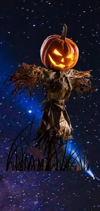 This phone live wallpaper showcases a scarecrow with a jack-o'-lantern head on top of a pole, glowing in eerie colors