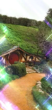 This phone live wallpaper features an enchanting scene of a cozy house situated atop a lush green hillside
