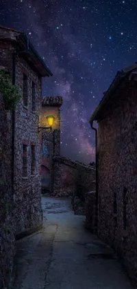 This phone live wallpaper features a charming street with a light at the end of it, set in a small medieval village
