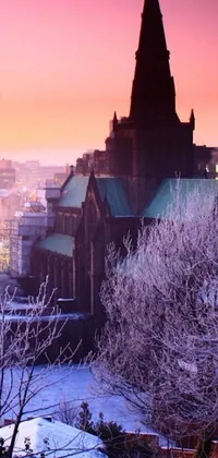 Are you in search of a stunning live wallpaper for your phone? Look no further than this breathtaking view of the snow-covered city of Glasgow! The photograph, taken from a hilltop by an experienced photographer, showcases a stunningly colorful Gothic church surrounded by beautiful architecture