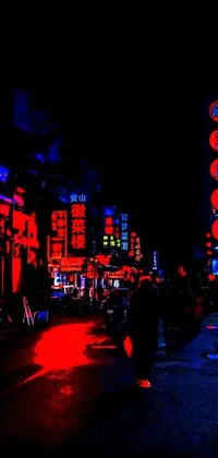 This phone live wallpaper features a bustling city street illuminated by neon signs and bathed in red and blue blacklight