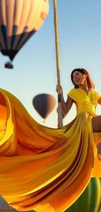 Looking for a stunning phone live wallpaper that&#39;s sure to impress? Check out this breathtaking scene - a woman sitting on a swing, surrounded by hot air balloons floating majestically in the background