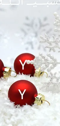 This live wallpaper features a group of red ornaments on a pile of snow with a "Merry Christmas and Happy Holidays" message written in white cursive font