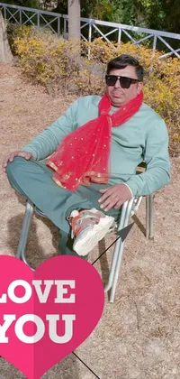 This phone live wallpaper showcases an eye-catching image of a man relaxing in a lawn chair with a red scarf hung over his shoulders