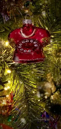 This live wallpaper for phones features a vintage-inspired Christmas ornament hanging from a festive tree