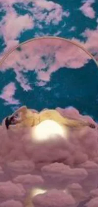 This circle-shaped phone live wallpaper features a pink sun in the background and a woman lying on top of a cloud-covered sky