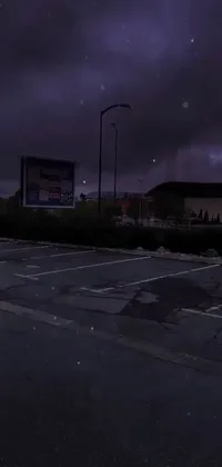 This phone live wallpaper displays a realistic night scene in an abandoned parking lot