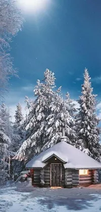 This live wallpaper for your phone features a charming cabin in a snowy forest