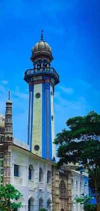 This live wallpaper boasts a beautiful Assamese-inspired painting, featuring a large blue and white building with a clock tower