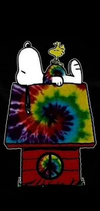 This live phone wallpaper features a tie-dye snoop sitting on top of a Snoopy-inspired house