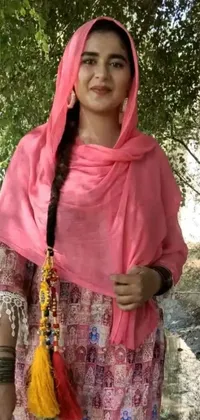 This stunning live wallpaper depicts a graceful woman wearing a pink shawl standing beneath a tree